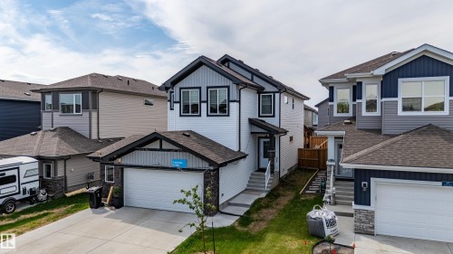 Contemporary two-story residence featuring white siding and black trim accents - 41 Sequoia Bend, Fort Saskatchewan, AB 