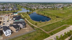 Expansive neighborhood featuring multiple bodies of water surrounded by green spaces and paved pathways - 