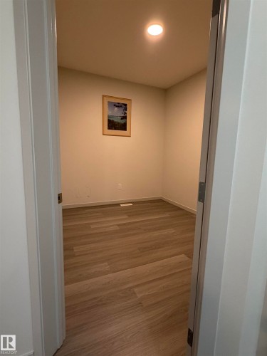 Interior room featuring wood-finish flooring, recessed ceiling lighting, and light-toned wall paint - 41 Sequoia Bend, Fort Saskatchewan, AB 