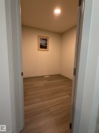 Interior room featuring wood-finish flooring, recessed ceiling lighting, and light-toned wall paint - 