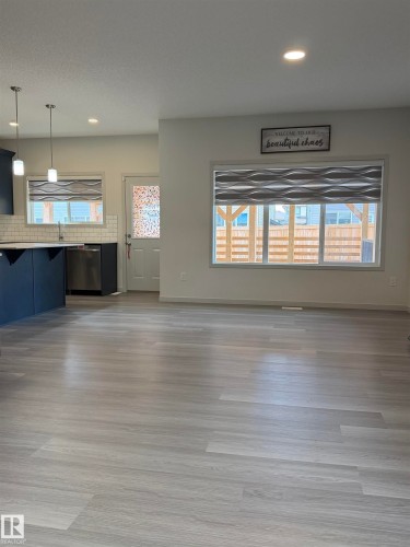 Open-concept living space with light-tone wood-finish flooring - 41 Sequoia Bend, Fort Saskatchewan, AB 