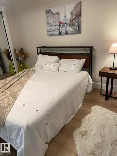 Light wood-finish flooring with a neutral wall color - 3830 22 Street Nw, Edmonton, AB 