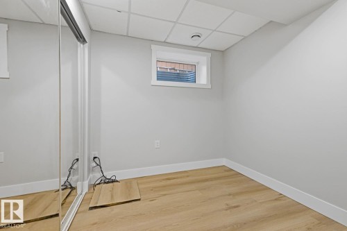 Wood-finish flooring with white trim and light gray walls - 3830 22 Street Nw, Edmonton, AB 