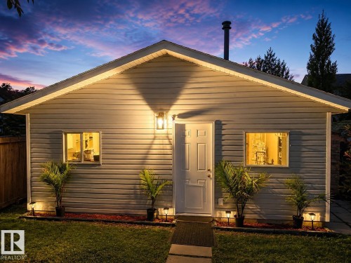 Gable roofline with siding exterior, single entry door, and two windows - 3830 22 Street Nw, Edmonton, AB 