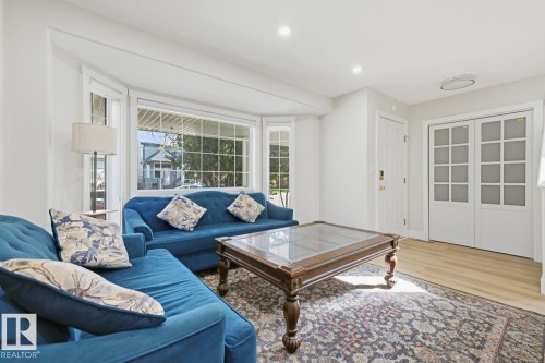 Bay window, recessed lighting, wood-finish flooring, white paneled entry door, double doors with frosted glass panels - 3830 22 Street Nw, Edmonton, AB 