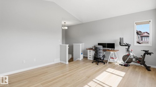 Light wood-finish flooring with neutral wall tones - 4610 Westcliff Point(E) Sw, Edmonton, AB 