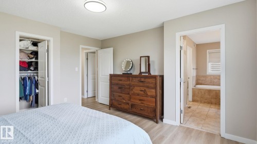 Wood-finish flooring with a neutral wall color, recessed ceiling light, and built-in closet - 4610 Westcliff Point(E) Sw, Edmonton, AB 