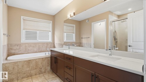 Built-in soaking tub, dual vanity with undermount sinks, frameless glass shower enclosure, and full-width mirror - 4610 Westcliff Point(E) Sw, Edmonton, AB 