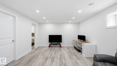 Recessed lighting, wood-finish flooring, white paneled interior door, and a built-in window - 4610 Westcliff Point(E) Sw, Edmonton, AB 