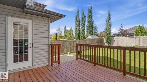 Wood-finish deck with a wood railing and a glass-paneled door - 4610 Westcliff Point(E) Sw, Edmonton, AB 