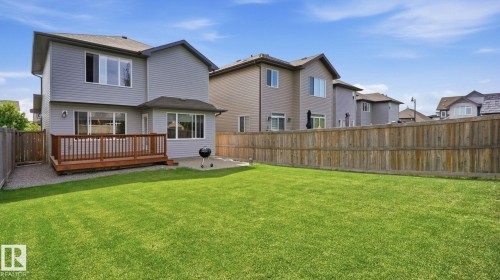 Spacious backyard featuring a manicured lawn, full wood fencing, and a wooden deck - 4610 Westcliff Point(E) Sw, Edmonton, AB 