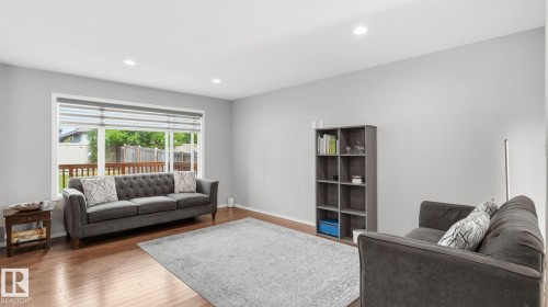 Recessed lighting, wood-finish flooring, white window trim, and a built-in shelving unit - 4610 Westcliff Point(E) Sw, Edmonton, AB 