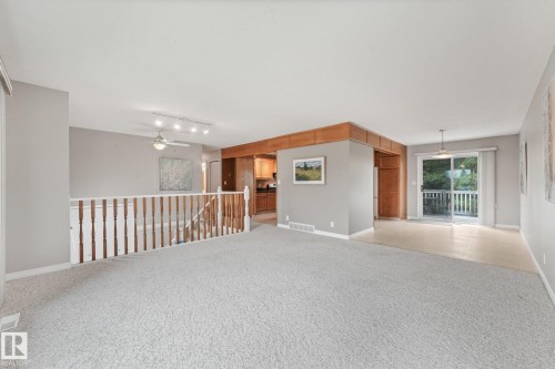 Carpeted living area with light gray walls and white trim - 5502 45 Street, Stony Plain, AB - Indoor Photo Showing Other Room