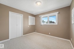 Bedroom featuring neutral paint, light-toned carpet, and a double-pane window - 