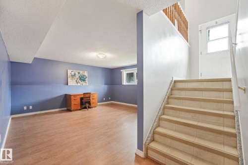 Finished lower level with wood-finish flooring and two-tone wall paint - 5502 45 Street, Stony Plain, AB - Indoor Photo Showing Other Room