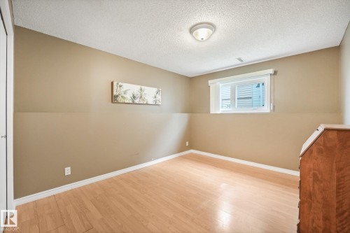 Room featuring neutral wall tones and wood-finish flooring - 5502 45 Street, Stony Plain, AB - Indoor Photo Showing Other Room