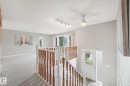 Split-level entryway featuring a white entry door with frosted glass sidelight - 5502 45 Street, Stony Plain, AB  - Indoor Photo Showing Other Room 