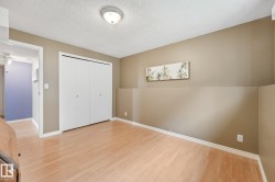 Room featuring wood-finish flooring, neutral-toned walls, white trim, and a flush mount ceiling light - 