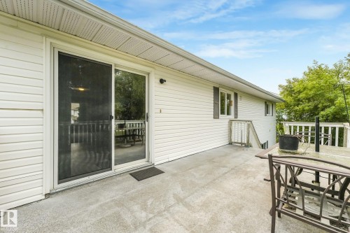 Expansive concrete patio offering direct access to the interior via a sliding glass door - 5502 45 Street, Stony Plain, AB - Outdoor With Deck Patio Veranda With Exterior