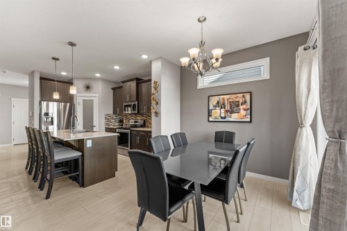 Wood-finish flooring, recessed lighting, and a kitchen island with pendant lighting - 12218 176 Avenue Nw, Edmonton, AB 