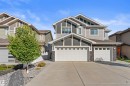 Contemporary exterior with multiple gables, a two-car garage, an additional single-car garage, and stone facade accents - 12218 176 Avenue Nw, Edmonton, AB 
