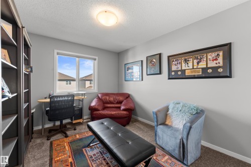 Built-in shelving unit, neutral wall color, window with white trim, and a flush mount ceiling light - 12218 176 Avenue Nw, Edmonton, AB 