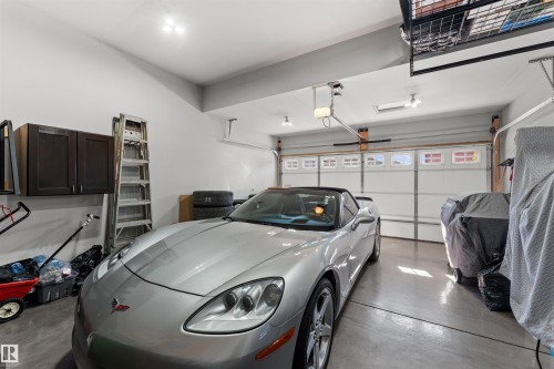 Vaulted garage ceiling with track lighting, suspended storage racks, and built-in cabinetry - 12218 176 Avenue Nw, Edmonton, AB 