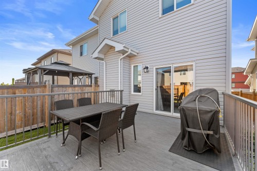 Rear deck with composite decking, aluminum railing, and a sliding glass door - 12218 176 Avenue Nw, Edmonton, AB 