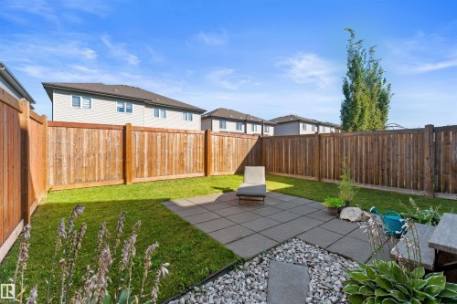 Private backyard featuring a paver patio and full privacy fencing - 12218 176 Avenue Nw, Edmonton, AB 