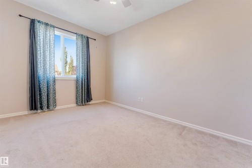 Carpeted flooring, single window, painted walls, ceiling fan, white trim - 1124 37A Avenue Nw, Edmonton, AB 