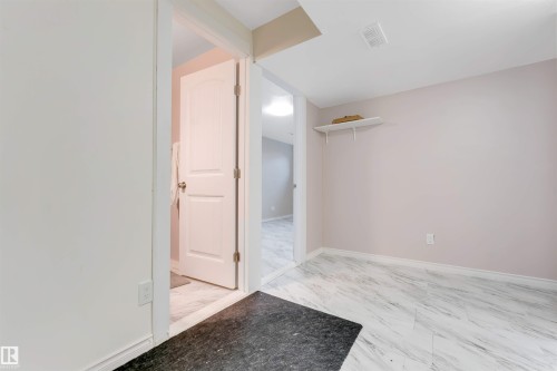 Light-toned wall finishes, white trim, and white wood-finish doors - 1124 37A Avenue Nw, Edmonton, AB 