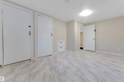 Neutral wall paint, light-colored flooring, recessed lighting, and built-in drawer storage - 