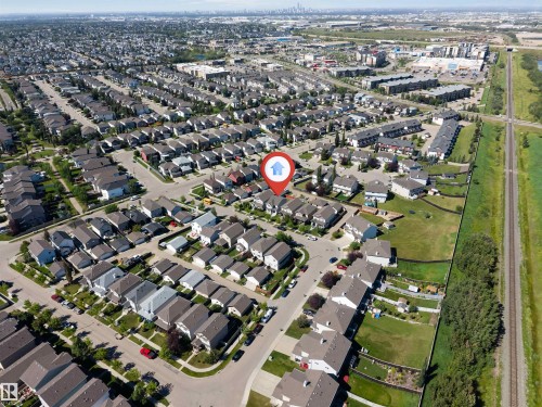 Aerial perspective showcasing a residential neighborhood with detached homes, urban density, and green spaces - 1124 37A Avenue Nw, Edmonton, AB 