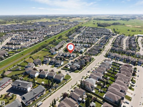 Residential subdivision with varied architectural styles, bordered by open fields and a linear green space - 1124 37A Avenue Nw, Edmonton, AB 