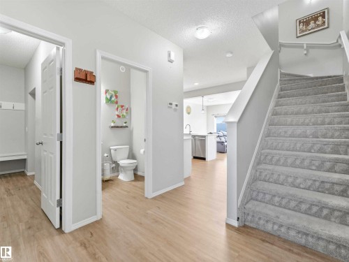 Wood-finish flooring throughout the main level - 2435 12 Avenue Nw, Edmonton, AB 