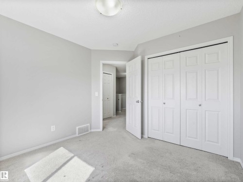 Wall-to-wall carpeting and neutral wall tones - 2435 12 Avenue Nw, Edmonton, AB 
