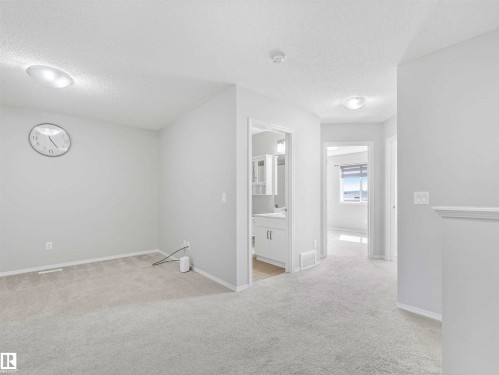 Plush carpet flooring throughout, with recessed lighting and a neutral color palette - 2435 12 Avenue Nw, Edmonton, AB 
