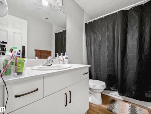 White vanity with integrated sink, chrome faucet, and bronze-finish hardware - 2435 12 Avenue Nw, Edmonton, AB 