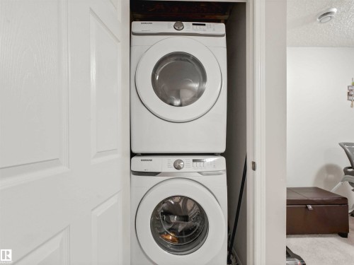 Stacked white washer and dryer unit - 2435 12 Avenue Nw, Edmonton, AB 