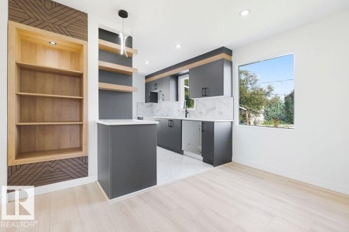 Built-in shelving with recessed lighting, wood-finish flooring, matte gray cabinetry, stone-finish countertops, and a white tile backsplash - 12303 131 St Nw Nw, Edmonton, AB 
