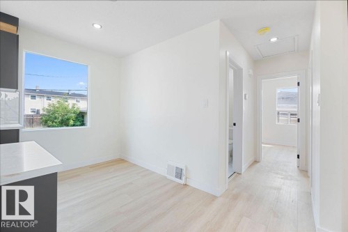 Wood-finish flooring, recessed lighting, and white walls throughout - 12303 131 St Nw Nw, Edmonton, AB 