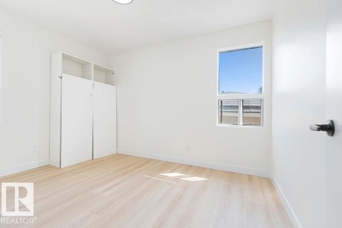 Recessed ceiling light, built-in white cabinetry, wood-finish flooring, and white walls - 12303 131 St Nw Nw, Edmonton, AB 