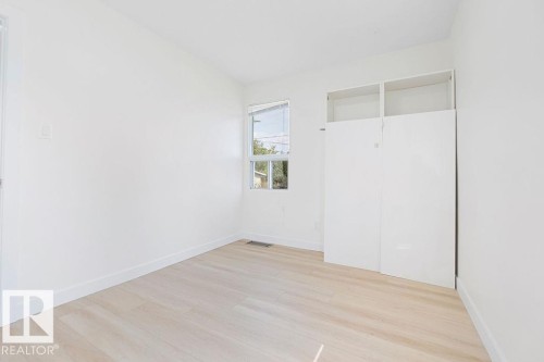 Light wood-finish flooring with white walls - 12303 131 St Nw Nw, Edmonton, AB 