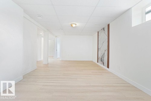 Wood-finish flooring with crisp white walls and ceiling - 12303 131 St Nw Nw, Edmonton, AB 