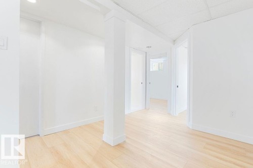 Light wood-finish flooring with white walls and ceiling - 12303 131 St Nw Nw, Edmonton, AB 