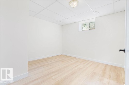 Recessed ceiling with an overhead light fixture, light wood-finish flooring, and a window - 12303 131 St Nw Nw, Edmonton, AB 