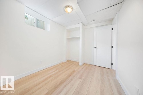 Light wood-finish flooring with white walls - 12303 131 St Nw Nw, Edmonton, AB 