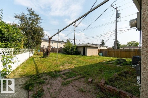 Spacious backyard featuring a storage shed, wood fence, and white lattice fence - 12303 131 St Nw Nw, Edmonton, AB 