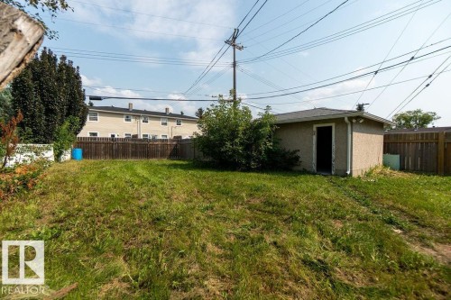 Detached stucco structure with a shingled roof, offering privacy with surrounding wood fencing - 12303 131 St Nw Nw, Edmonton, AB 