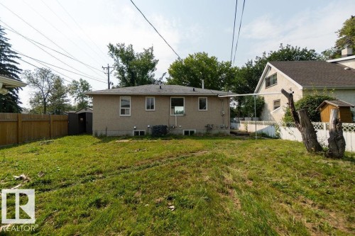 Rear exterior with stucco siding, a wood fence, and a backyard shed - 12303 131 St Nw Nw, Edmonton, AB 